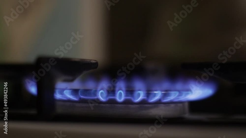 Kitchen burner turning on.Stove top burner igniting into a blue cooking flame.