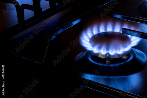 Gas burner with burnig methane on dark background photo