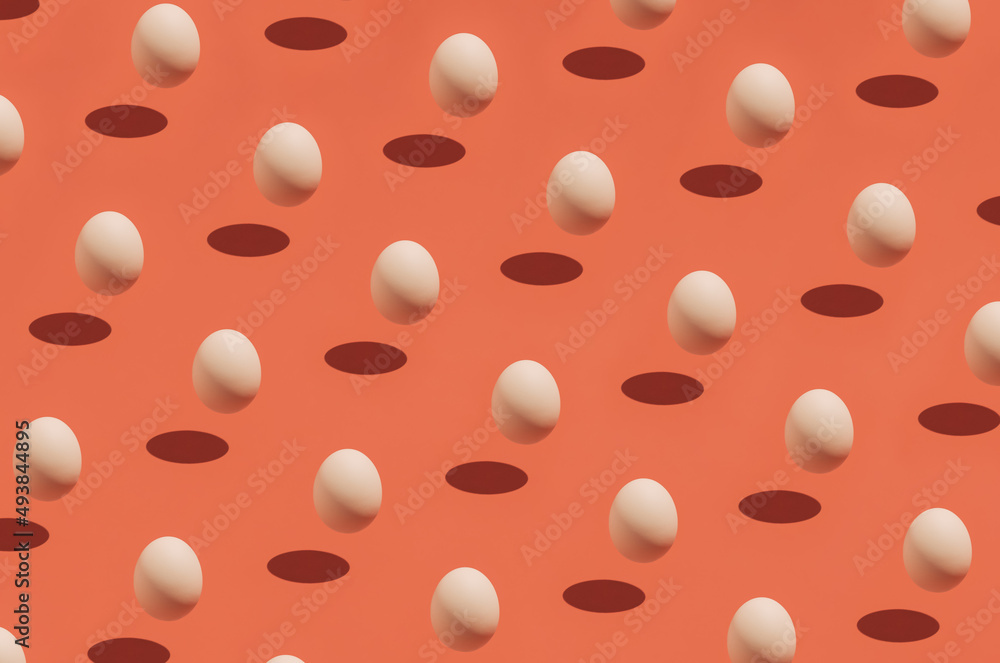 Easter season egg idea with visual pattern on festive orange background. Creative holiday and spring season concept, minimal food and shadow composition. Easter season egg idea with visual pattern on festive orange background. Creative holiday and spring season concept, minimal food and shadow composition.
