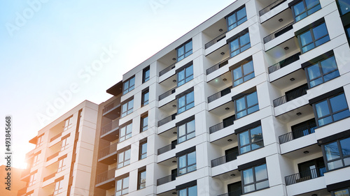 Modern european residential architecture on a sunny day. Exterior of new multi-story residential building. Concept of sale and rental of apartments for consumers .Modern windows and balconies.