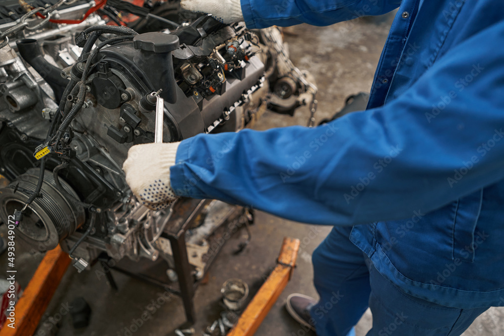 Mechanic holding tool in hands and repairing Mechanic holding tool in hands and repairing