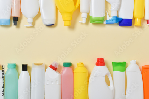 Various plastic bottles scattered on a yellow background