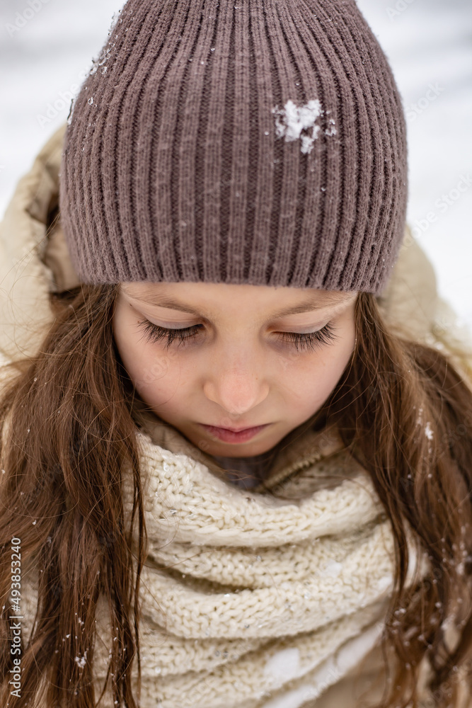 portrait of a cute six-year-old girl in a beige jacket, brown hat portrait of a cute six-year-old girl in a beige jacket, brown hat