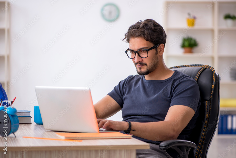 Young male designer working in the office Young male designer working in the office