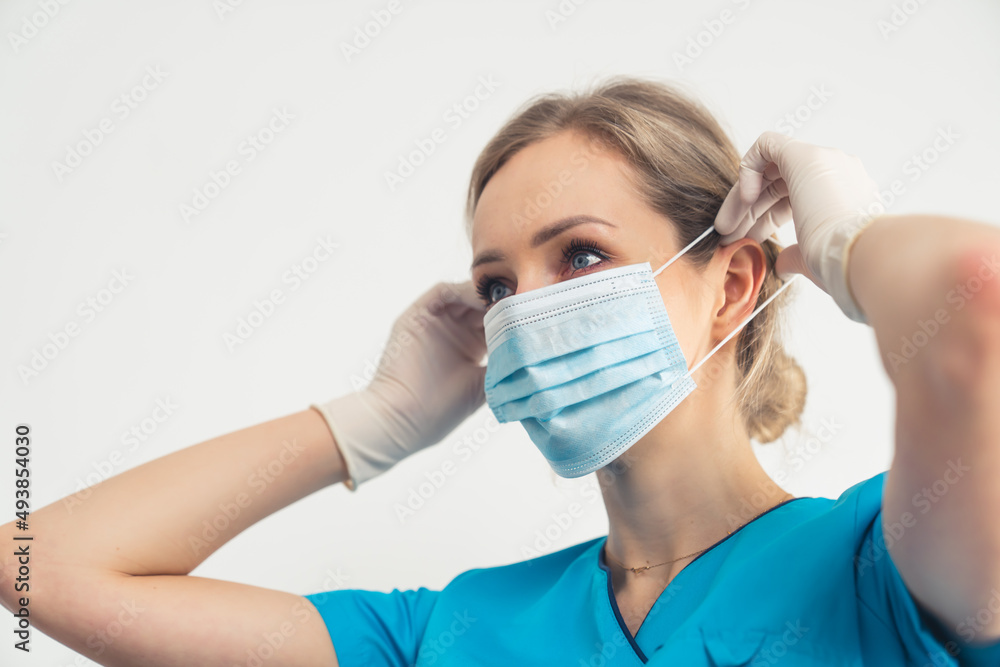Responsible Nurse Putting On Medical Face Mask. Protection from bacteria and viruses. High quality photo