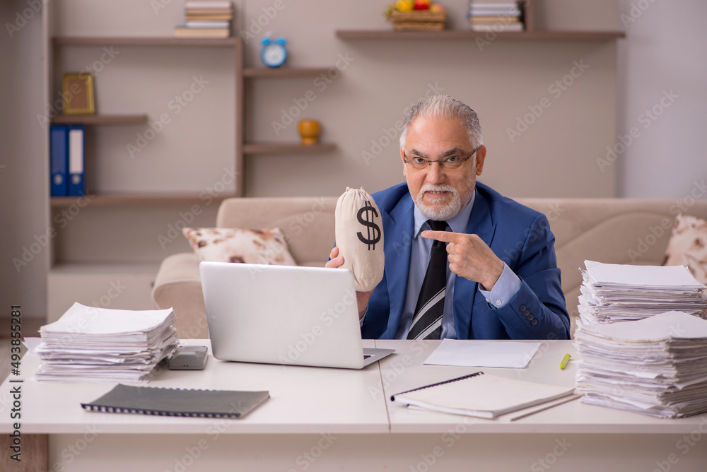 Old male boss working from home in remuneration concept Old male boss working from home in remuneration concept