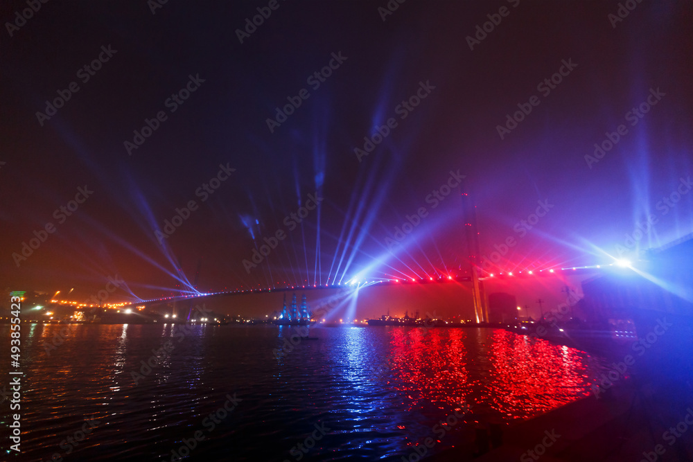 Light show of the Golden Bridge in Vladivostok. Bridge across the Golden Horn Bay at night. Light show of the Golden Bridge in Vladivostok. Bridge across the Golden Horn Bay at night.