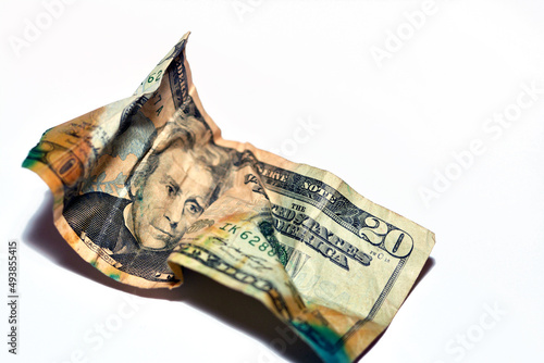 Selective focus of crumpled obverse American money of 20 $ twenty dollars bill isolated on white background, wrinkled American dollar cash bill banknote, economy inflation and money crisis concept photo