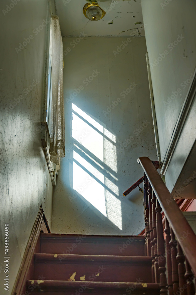 Fototapeta premium Old house with dramatic light, window textured backgrounds photograph.