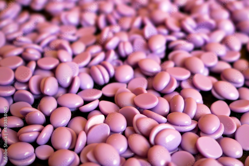 depilatory waxing - closeup of purple hard wax beans for women with sensitive skin