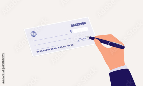 Close-Up View Of A Businessman’s Hand With Pen Signing A Cheque.  photo