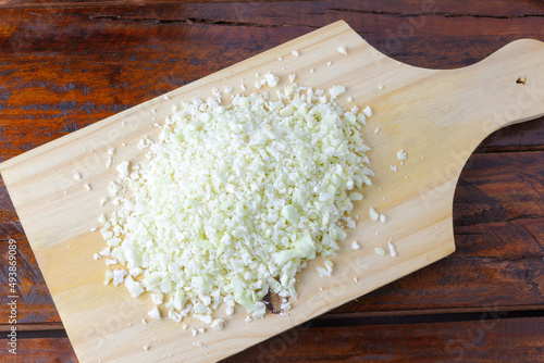 raw homemade cauliflower rice over rustic wooden table photo