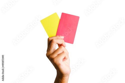 Selective focus of hand holding yellow and red card. Sports offence and law violation concept.