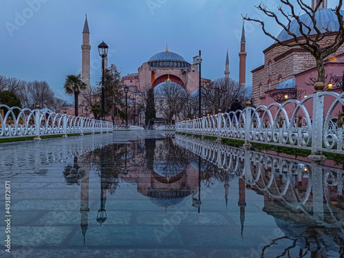 view of mosque reflected from puddle