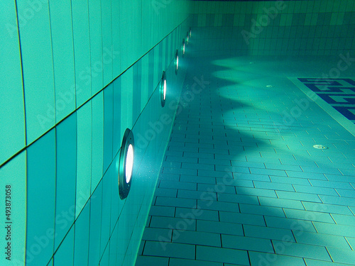 Pool lights underwater with blue tiles