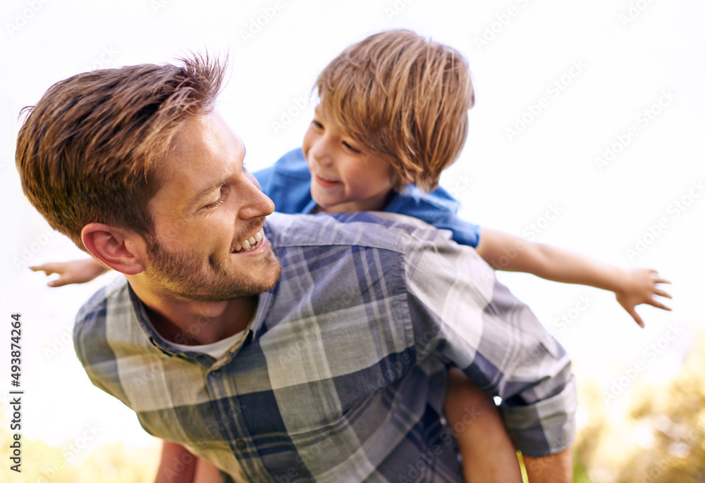 He loves his little boy so much. Cropped shot of a young father giving his son a piggyback ride. He loves his little boy so much. Cropped shot of a young father giving his son a piggyback ride.