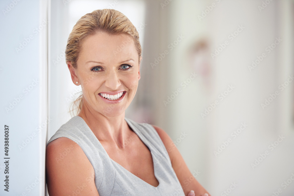 Success makes me smile. Cropped portrait of an attractive businesswoman standing in the office. Success makes me smile. Cropped portrait of an attractive businesswoman standing in the office.