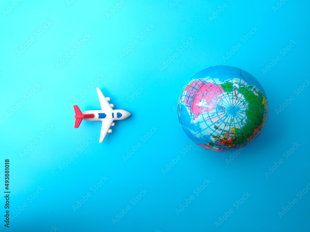 Top view airplane with earth globe on a blue sky background. Travel concept. Top view airplane with earth globe on a blue sky background. Travel concept.