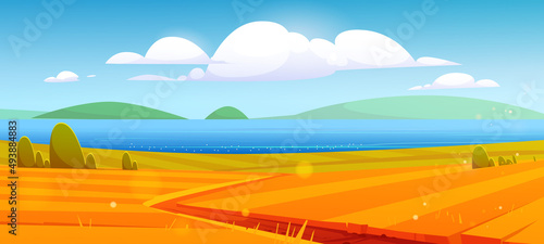 Autumn nature landscape, rural dirt road going through yellow field to blue sea shore or lake. Cartoon fall season scenery background with path under blue sky with fluffy clouds, Vector illustration