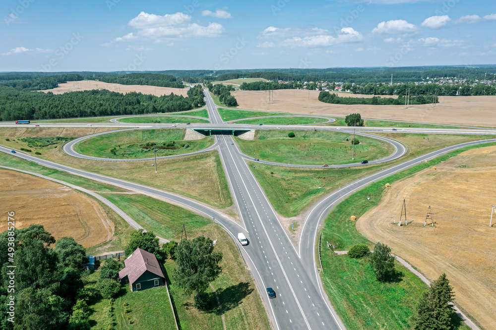 highway road intersection in countryside. aerial view in sunny summer day.