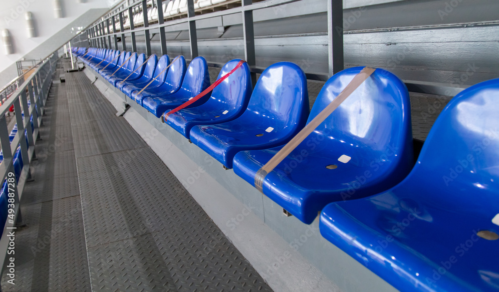 Naklejka premium Blue seats on the stadium tribune.