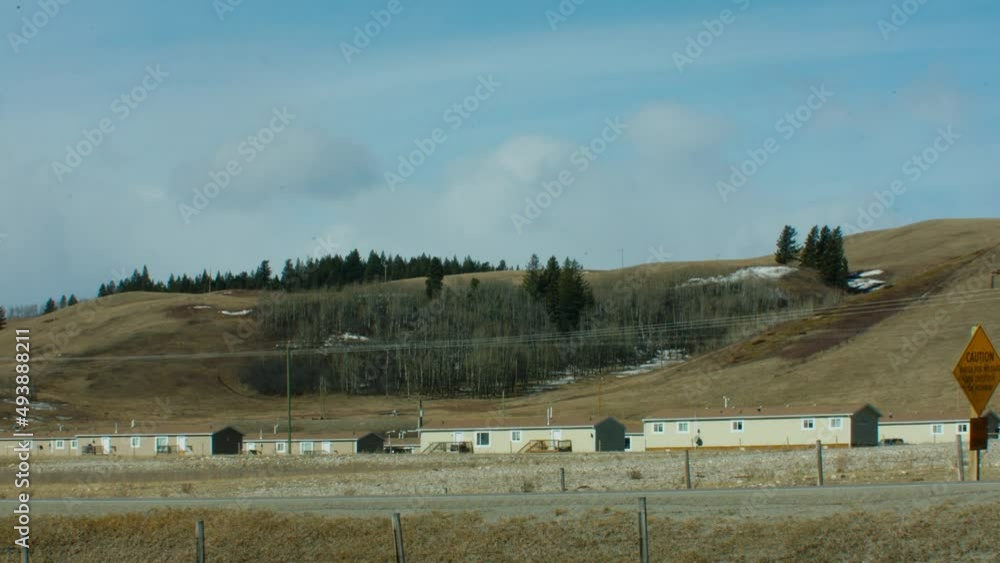 Affordable housing in rural area wide car passing by Affordable housing in rural area wide car passing by