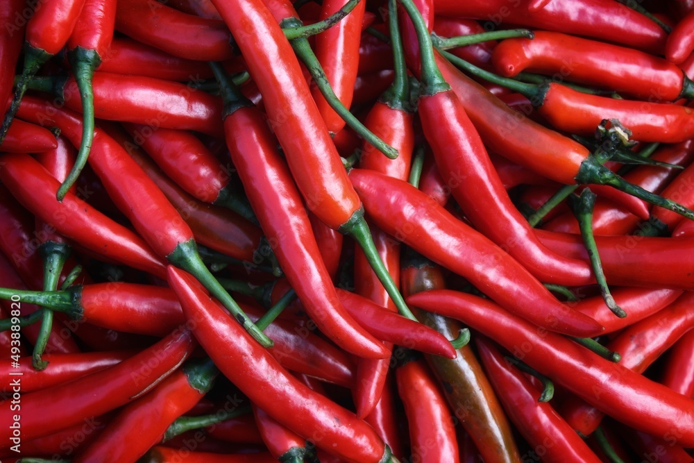 A bulk display of hot red peppers