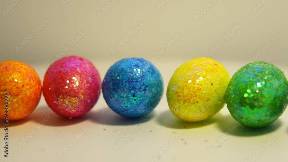 Colorful Easter eggs rotating in rows in a seamless loop on a light background