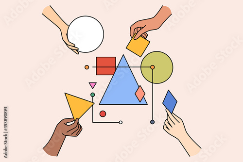 Multiethnic work team connect geometrical shapes and figures involved in teambuilding activity. Hands building system together. Partnership and teamwork concept. Vector illustration. 