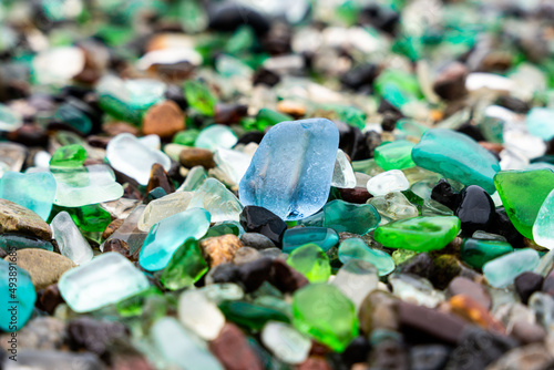 Glass Bay in Vladivostok. Sea-polished colored glass on the beach. Background, texture