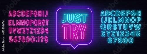 Just Try neon sign in the speech bubble on brick wall background.