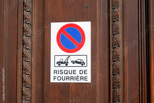 risque de fourriere sign evacuation french text means risk car impound front of personal home entrance door garage photo