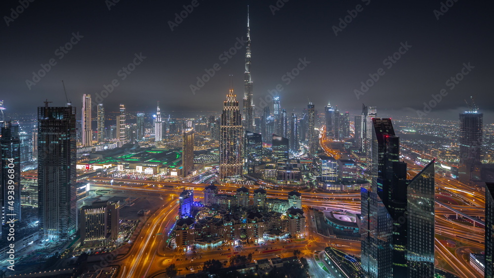 Aerial view of tallest towers in Dubai Downtown skyline and highway night timelapse. Aerial view of tallest towers in Dubai Downtown skyline and highway night timelapse.