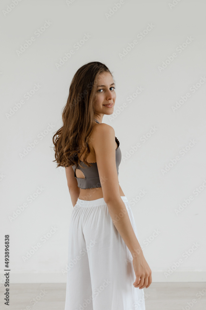 Girl with wavy hair stands smiling after a workout Girl with wavy hair stands smiling after a workout