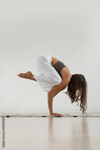 Yoga girl. The girl stands on her hands