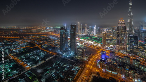 Aerial view of tallest towers in Dubai Downtown skyline and highway night timelapse. © neiezhmakov