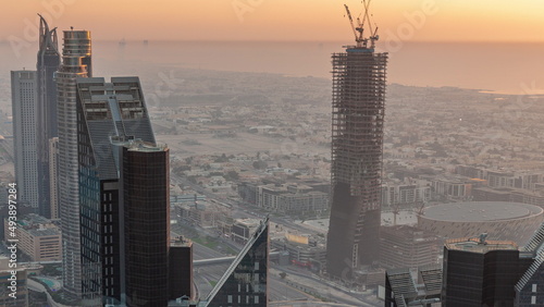 Downtown skyline with modern architecture form above timelapse. Aerial view of Dubai business bay towers. photo