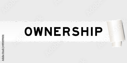 Ripped gray paper background that have word ownership under torn part