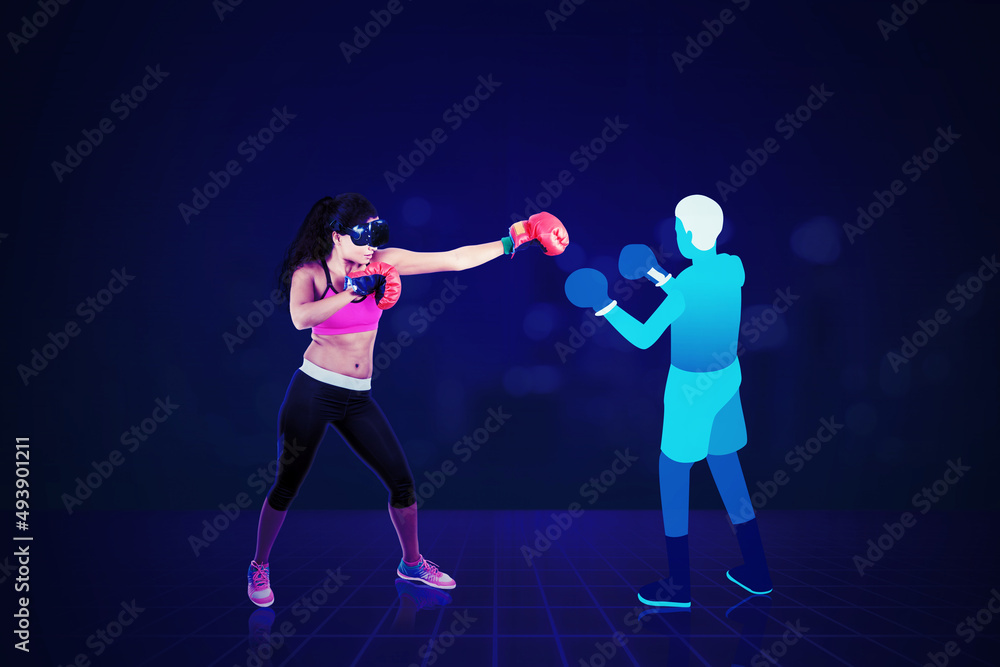Young woman having boxing exercise in metaverse Young woman having boxing exercise in metaverse