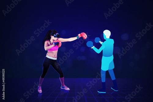 Young woman having boxing exercise in metaverse
