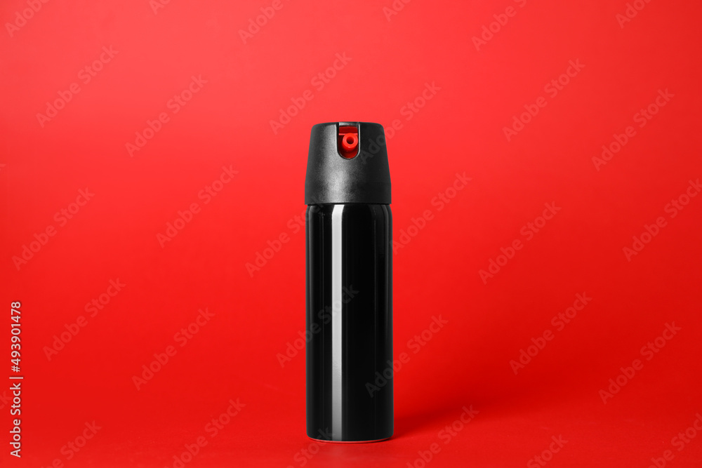 Bottle of gas pepper spray on red background Bottle of gas pepper spray on red background