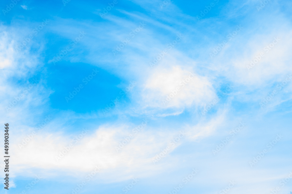 Huge clouds in blue sky lit by the sun, windy day. Beautiful sky background. Huge clouds in blue sky lit by the sun, windy day. Beautiful sky background.