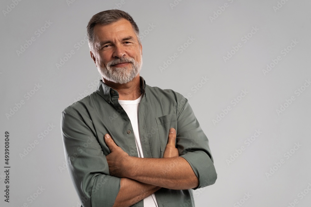 Portrait of smiling mature man standing on white background Portrait of smiling mature man standing on white background
