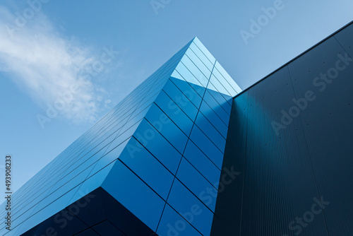 Geometric colored building facade elements with planes, lines and corners with light flare and reflections for an abstract background and texture of white, blue, gray colors. Place for text