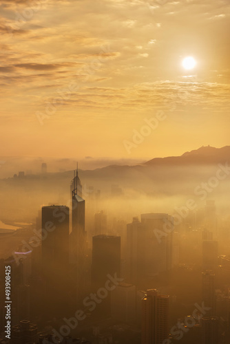 Obraz na płótnie Skyscraper in downtown district of Hong Kong city in fog under sunrise w salonie