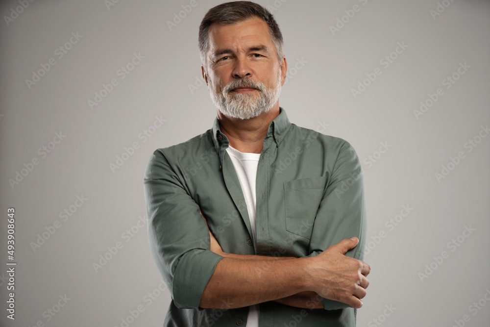 Portrait of smiling mature man standing on white background Portrait of smiling mature man standing on white background