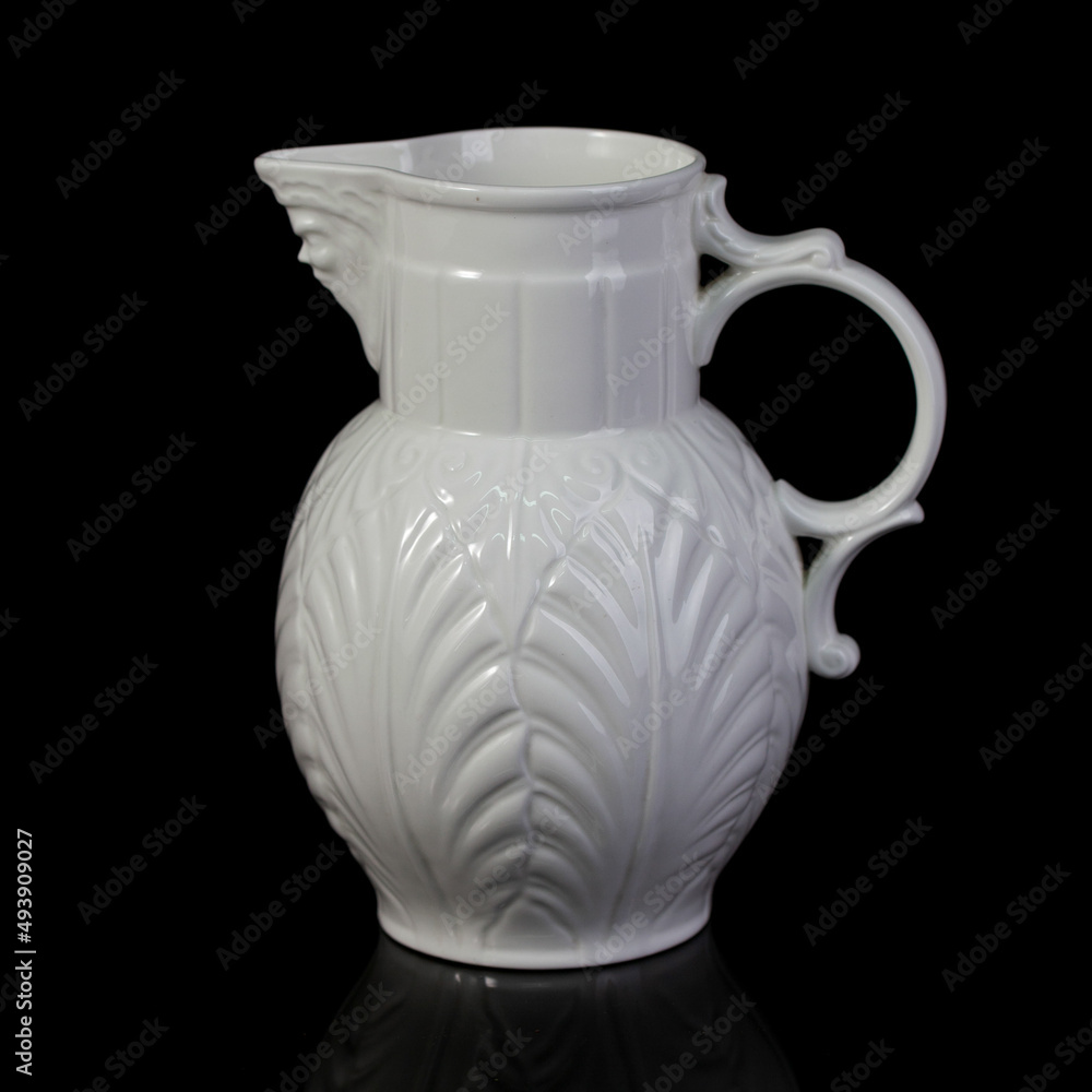 antique white porcelain vase in on a black isolated background. antique ceramic vase with stucco