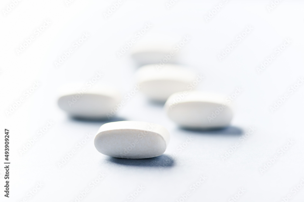Lysine tablets. Concept for a healthy dietary supplementation. Nervous System Support. Soft focus. Bright background. Close up. Copy space. Lysine tablets. Concept for a healthy dietary supplementation. Nervous System Support. Soft focus. Bright background. Close up. Copy space.