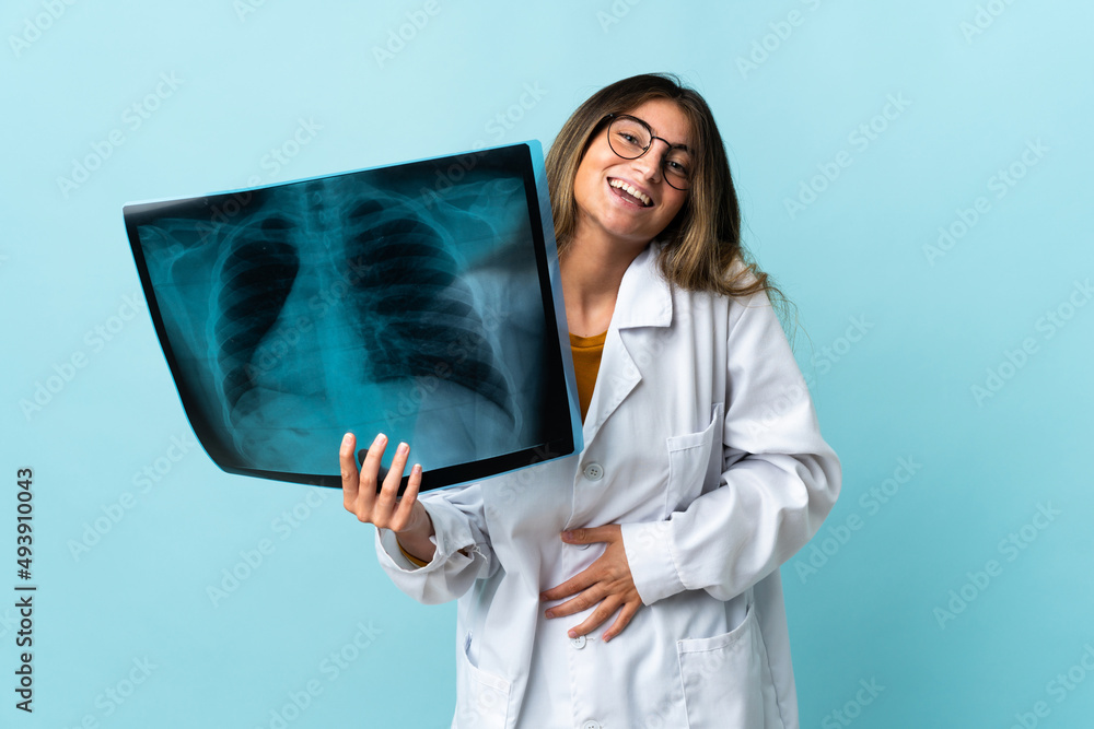 Professional traumatologist isolated on blue background smiling a lot Professional traumatologist isolated on blue background smiling a lot