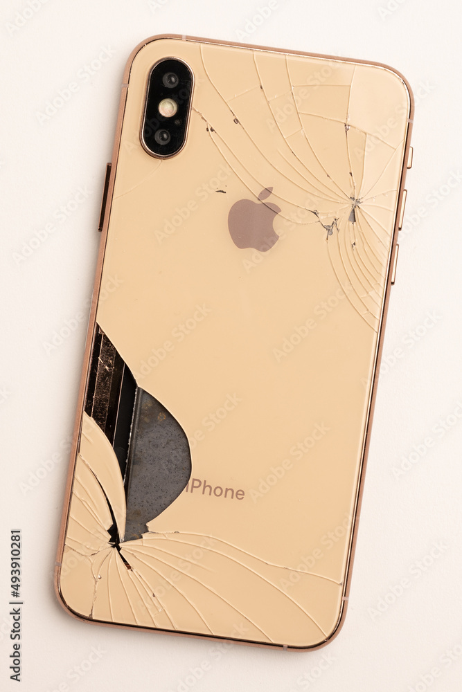 Top view the back of smartphone iPhone 11 with a broken glass and a damaged  curved body close-up Photos | Adobe Stock